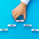 Skill concept. Businessman holding wooden blocks stacking as step stair with skill basic links on y