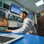 Man managing network of data center from computer