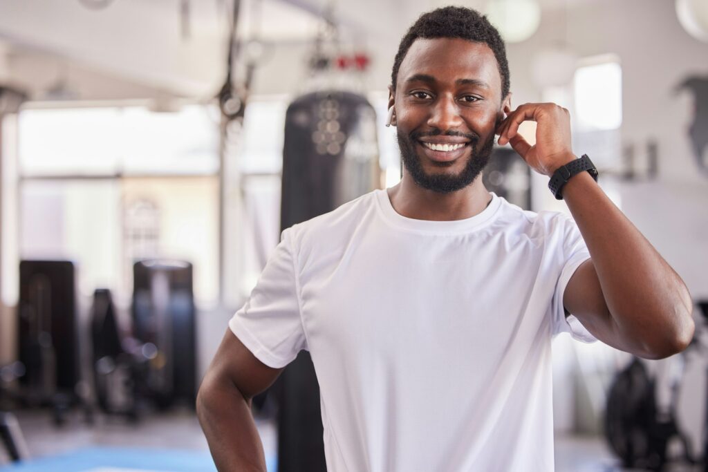 Portrait of black man, personal trainer at gym and workout athlete ready for fitness exercise, hea