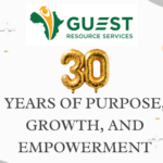 Guest Resource Services 30th anniversary graphic with gold balloons, orange streamers, and the text "30 Years of Purpose, Growth, and Empowerment.