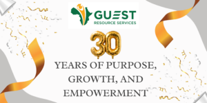Guest Resource Services 30th anniversary graphic with gold balloons, orange streamers, and the text "30 Years of Purpose, Growth, and Empowerment.